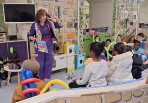 Children watching a magic show with Auntie Julie